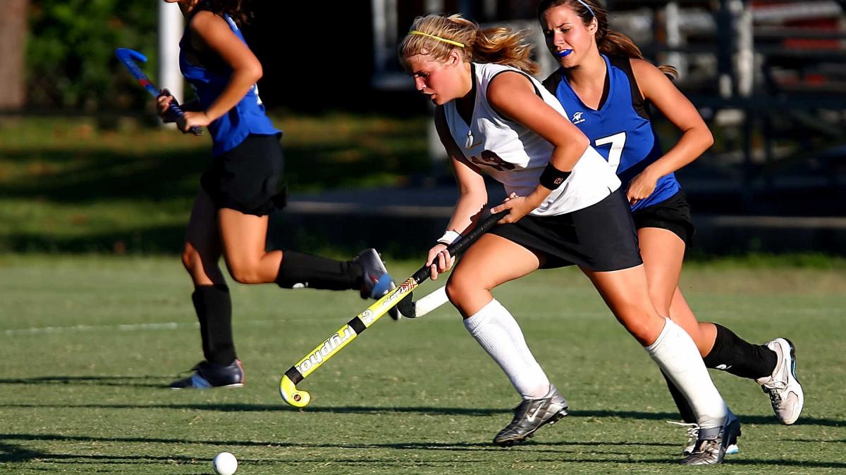 Women playing hockey